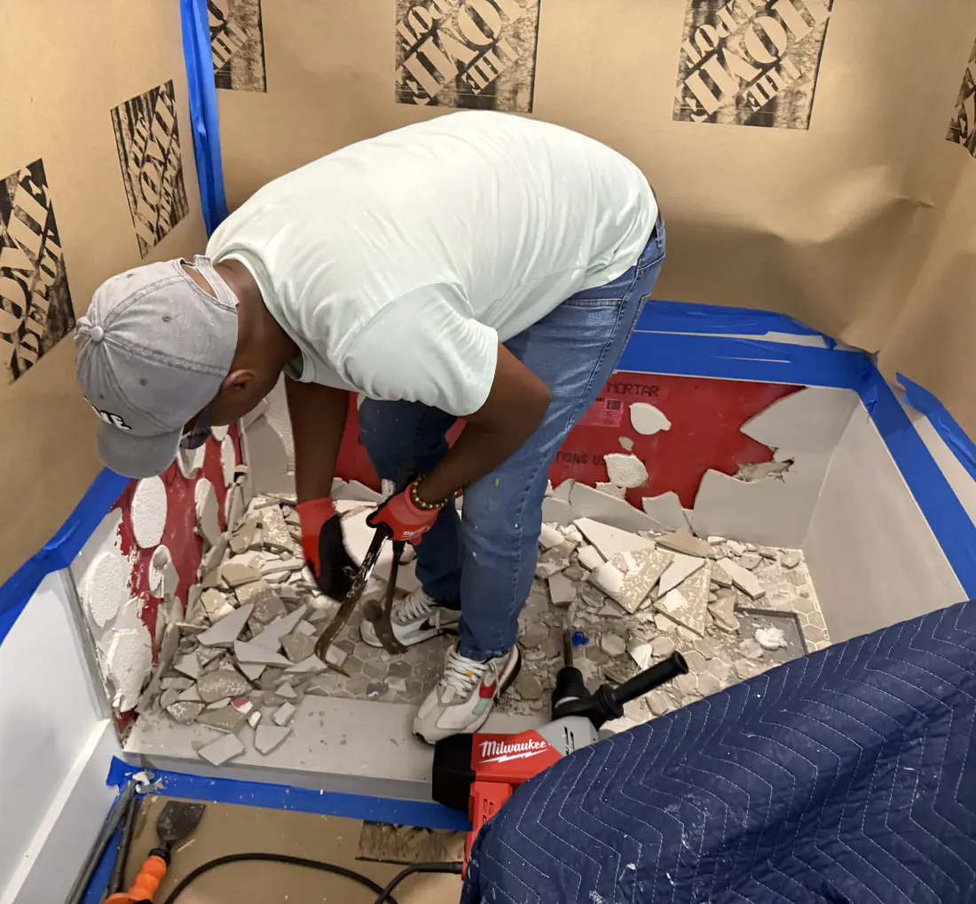 Ibis Repair Group crew removing old bathroom tile