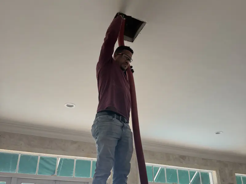 Technician fitting a ceiling vent