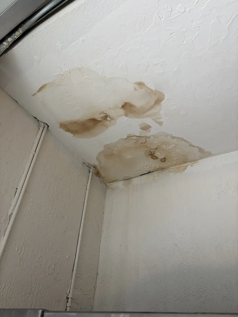 Water-stained ceiling from a roof leak after a storm
