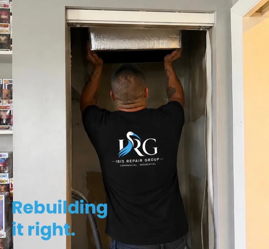 Ibis Repair Group technician fitting a new unit, in a company shirt