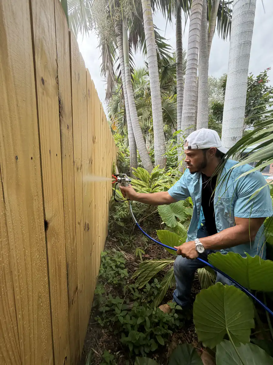 Ibis Repair Group crew cleaning a wood fence after storm season