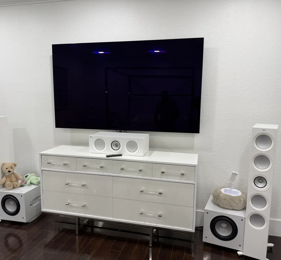 Media wall and speakers installed in a living room