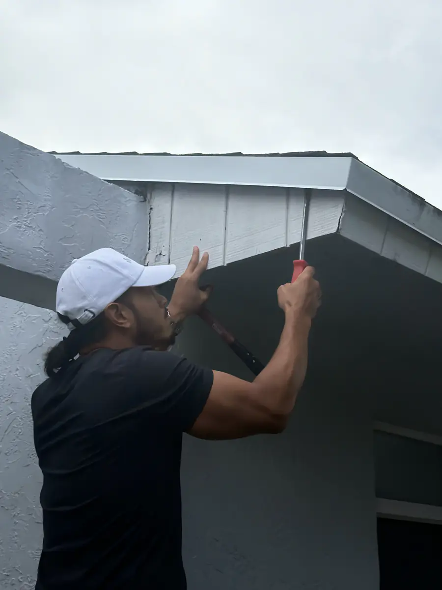 Ibis Repair Group technician painting a rebuilt soffit